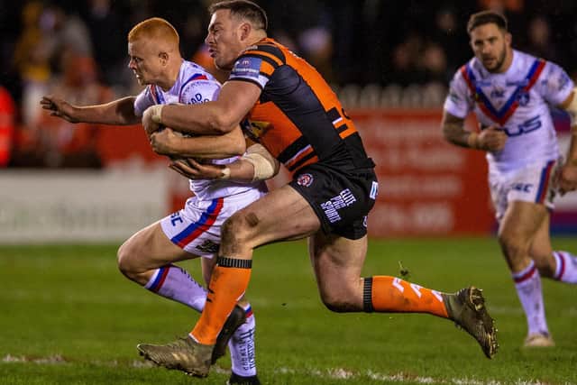 Trinity's Josh Wood tries to escape from a tackle by Grant Millington of Castleford. Picture by Bruce Rollinson.