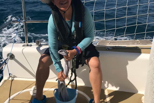 Theresia Cadwallader washing clothes while out at sea.