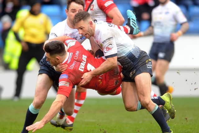 Richie Myler and Luke Gale tackle Niall Evalds.