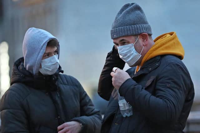 People wearing face masks as four new cases of coronavirus have been confirmed on Monday (Photo: Yui Mok/PA Wire)