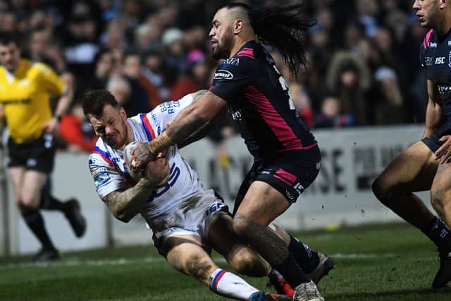 Wakefield Trinity's Tom Johnstone is tackled by Hull's Mahe Fonua. Picture: Jonathan Gawthorpe.