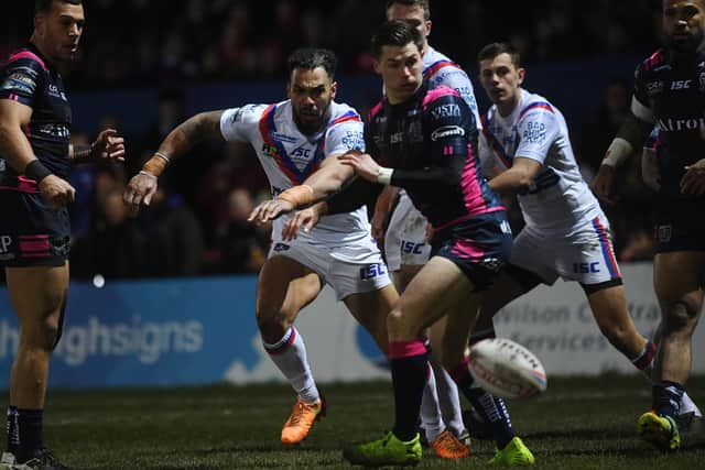 Wakefield Trinity's Ryan Atkins kicks through, on his way to score the opening try. Picture: Jonathan Gawthorpe