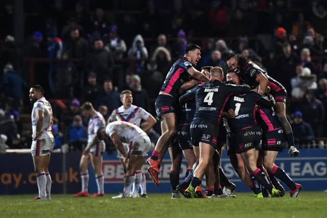Hull FC's players celebrate Marc Sneyd's golden-point drop goal. Picture: Jonathan Gawthorpe