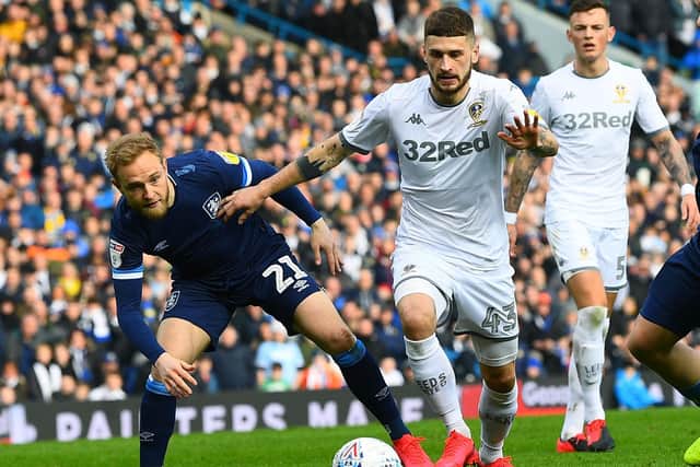 Huddersfield's Alex Pritchard battles with Leeds United's Mateusz Klich at Elland Road. (Image: Jonathan Gawthorpe)