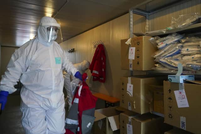 Red Cross personnel prepare for the transport of a Coronavirus patient during a simulation, in Rome. Credit: AP Photo/Andrew Medichini