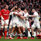 England's Anthony Watson (No.14) celebrates with his team-mates after scoring a try against Wales.