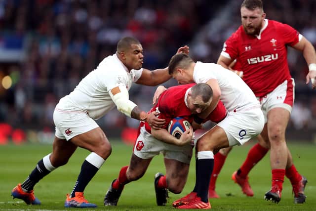 Wales' Ken Owens (centre) tackled by England's Kyle Sinckler (left) and Ben Youngs. Picture: David Davies/PA
