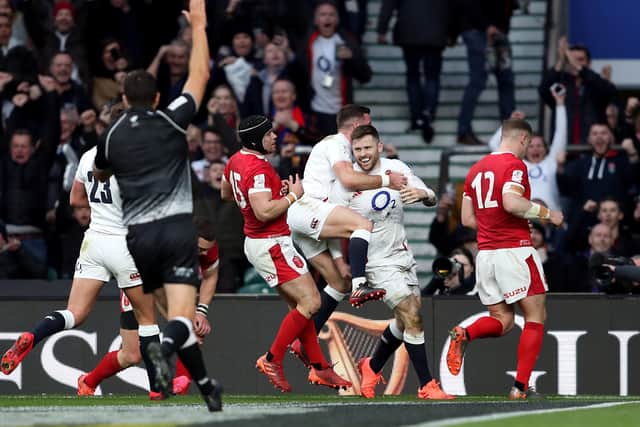 England's Elliot Daly (centre) celebrates scoring his side's second try of the game at Twickenham. Picture: David Davies/PA