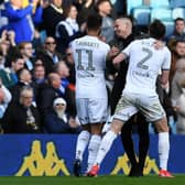 Kalvin Phillips congratulates Tyler Roberts and Luke Ayling at full time.