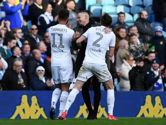 Kalvin Phillips congratulates Tyler Roberts and Luke Ayling at full time.