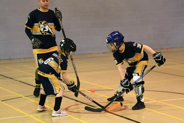 FACE OFF: Two members of the South Leeds Rams Ball Hockey Club juniors section battle for the ball during training at Middleton Leisure Centre.
 Picture: Jonathan Gawthorpe.