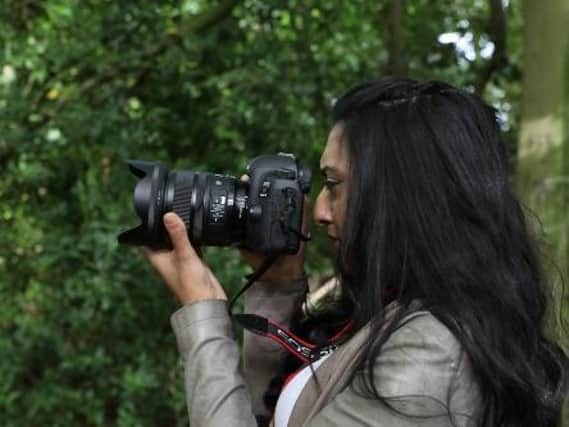 Leeds student Aqsa Kauser at work with her camera