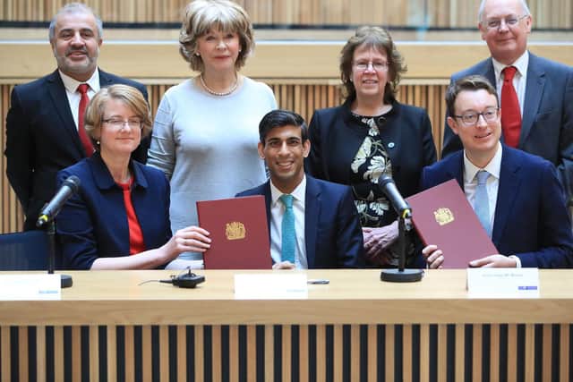 Chancellor Rishi Sunak and Minister Simon Clarke pose with West Yorkshire leaders as the devolution deal is signed. Pic: Danny Lawson PA