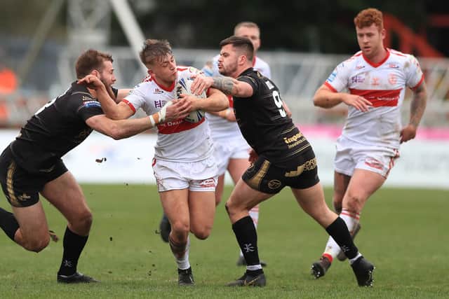 Hull KR's Mikey Lewis is tackled by Leigh Centurions'  Thomas Spencer and Liam Hood.