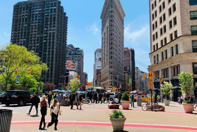 People walk past the Flatiron Building in New York. PIC: Getty