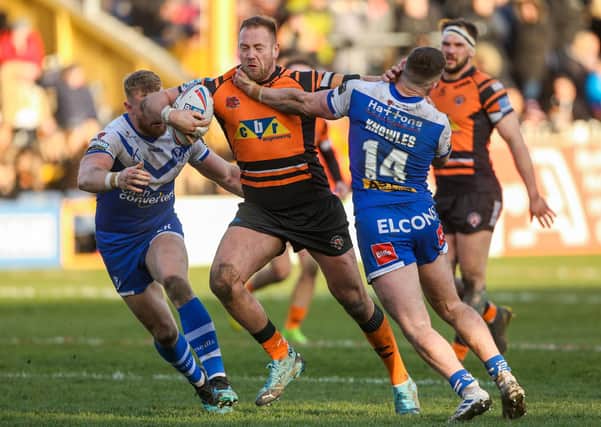 Castleford's Liam Watts is tackled by St Helens' Morgan Knowles and Luke Thompson. Picture: Alex Whitehead/SWpix.com