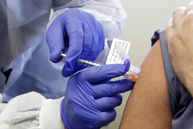 Neal Browning receives a shot in the first-stage safety study clinical trial of a potential vaccine for COVID-19.