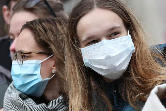 Spectators wearing masks to protect against coronavirus in London.  Photo credit: Jonathan Brady