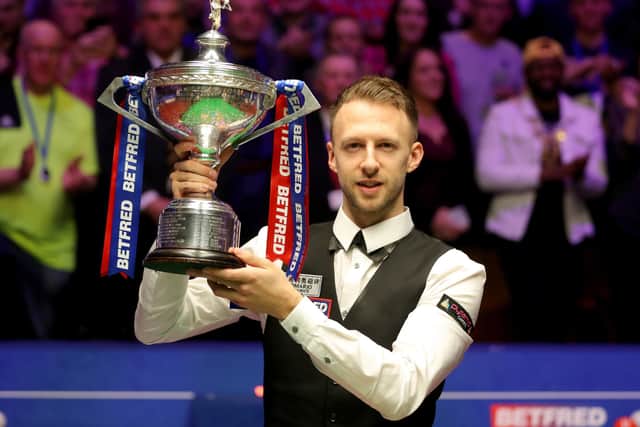 Judd Trump celebrates with the trophy after winning the 2019 Betfred World Championship at The Crucible. Picture: Richard Sellers/PA