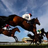 Cnoc Sion ridden by jockey David Noonan (red hat) clear a fence during the Central Roofing Handicap Chase at Hereford Racecourse on Monday. Picture: David Davies/PA