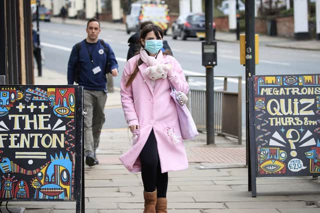A woman wearing a face mask walks past The Fenton pub in Leeds (photo: Danny Lawson/PA Wire).