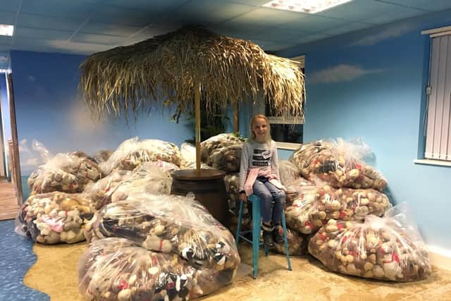 Maggie Snodgrass, nine, with the bagged up teddies after Event Prop Hire offered up their office as a teddy bears' picnic party.