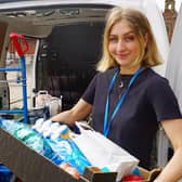 A member of staff from the Tiled Hall Caf at Leeds Art Gallery helps to load up donations.