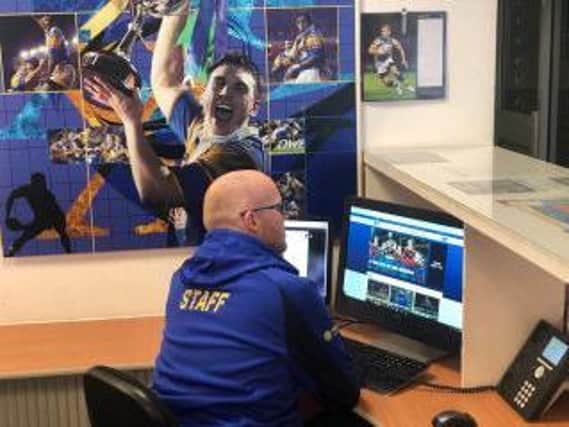 Ashley Marshall, of Leeds Rhinos' customer experience team, makes a welfare call. Picture by Sian Jones.