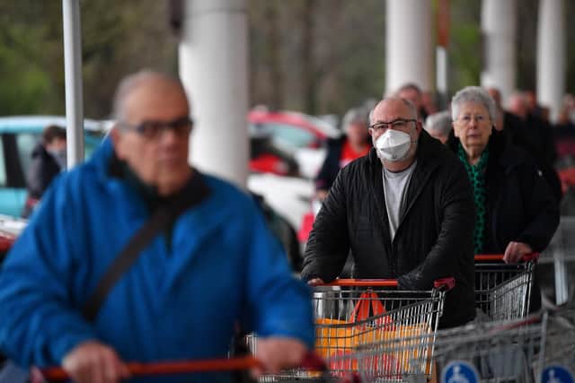 Shoppers queue outside a Sainsbury's supermarket during 'elderly only' hours. Photo: Getty