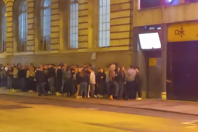 People queuing to get into The Acapulco Club on Friday during the coronavirus crisis. Photo taken by Rebecca Caswell.
