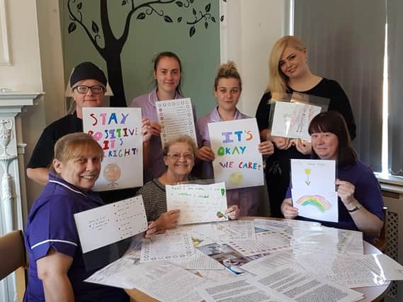 The Oakhaven Care Home team with letters and pictures sent in by wellwishers.
Care home manager Vickie Scott is pictured (back row/far right.)
Care home resident Mavis Thompson is pictured (front/ row centre)