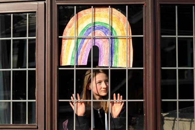 Fleur Hulme pictured with a rainbow in the window of her Leeds home.
