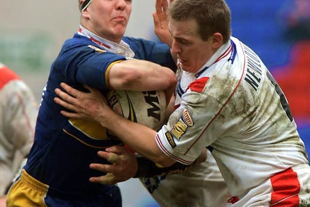 Matt Diskin is tackled by Paul Newlove and Anthony Sullivan.