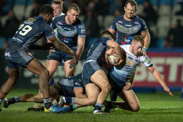 Featherstone Rovers' defence gets to grips with Jarrod O'Connor, of Leeds Rhinos, during a pre-season game in January. Picture by Bruce Rollinson.