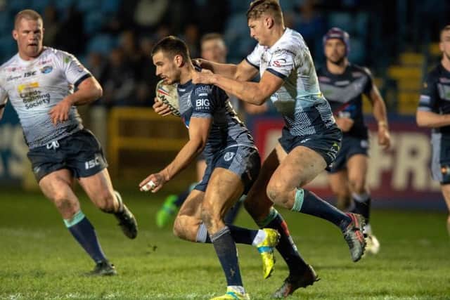 Featherstone Rovers' Gareth Gale gives Sam Walters, of Leeds Rhinos, a lift during this year's pre-seasn clasdh. Picture by Bruce Rollinson.