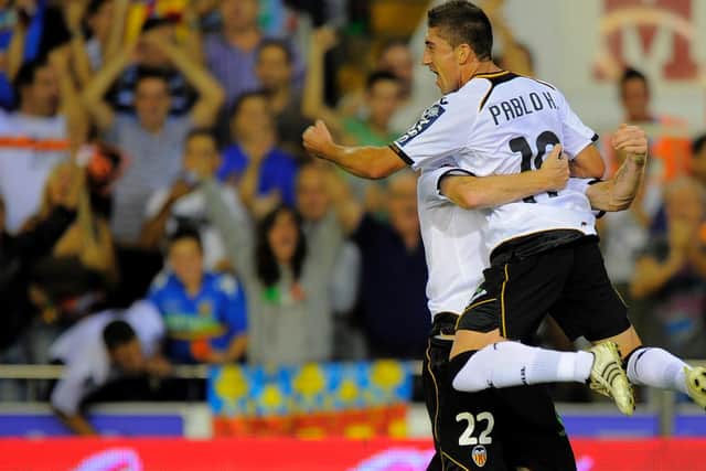 MEMORABLE: Pablo Hernandez celebrates with Jeremy Mathieu after putting Valencia 2-1 up in a 2-2 draw against La Liga visitors Barcelona at the Mestalla in September 2011. Photo by JOSE JORDAN/AFP via Getty Images.