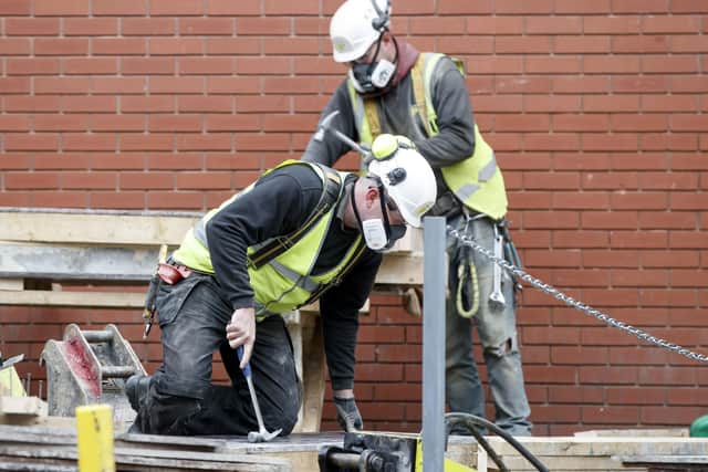 Workmen converting Harrogate Conference Centre into a Nightingale field hospital.