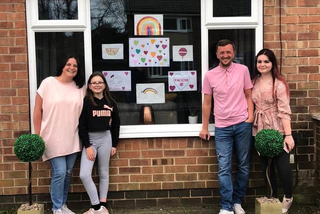 The Whitley family have drawn a chalk obstacle course to spread a bit of joy to their neighbours. Pictured is Sam Whitley, her husband Matthew and two children Macey and Mya.