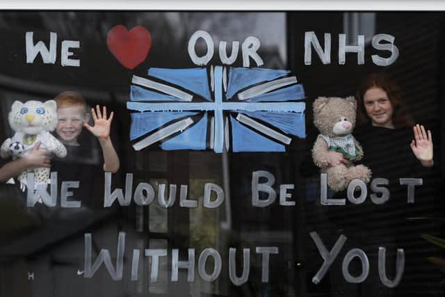 Lydia Hardwick, 11, with her brother Daniel, 8, support the NHS by painting their window at their home in Leeds.