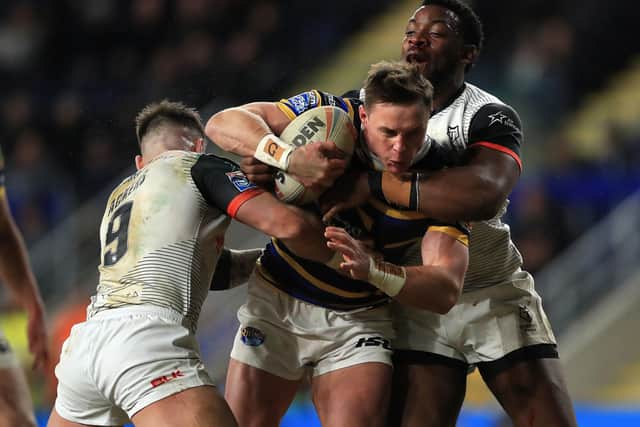 FINAL CHARGE: Leeds Rhinos' James Donaldson is tackled by Toronto Wolfpack's Gadwin Springer and Andy Ackers during the Rhinos' last match before the enforced suspension. Picture: PA.