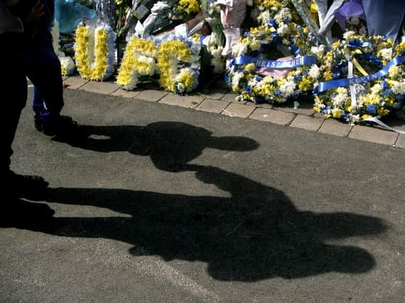 TRIBUTE: Floral tributes left at Elland Road in 2000 after the death of Leeds United supporters Kevin Speight and Christopher Loftus, who were killed in Istanbul before a UEFA Cup game against Galatasaray. Pic: Getty.