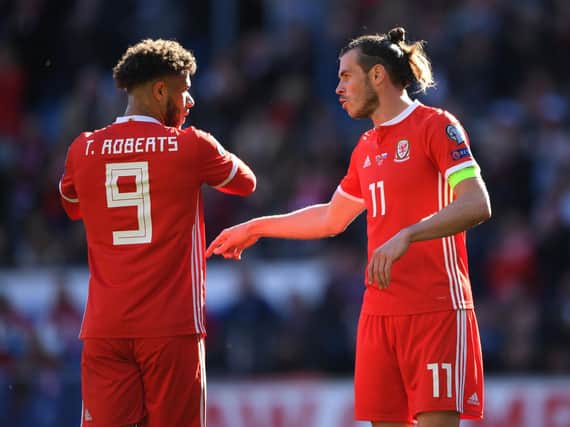 Tyler Roberts (L) and Gareth Bale (R) in action for Wales. (Image: Getty)