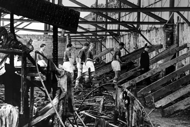Members of the 1956 Leeds United Team inspecting the West Stand, which was completely destroyed by fire.