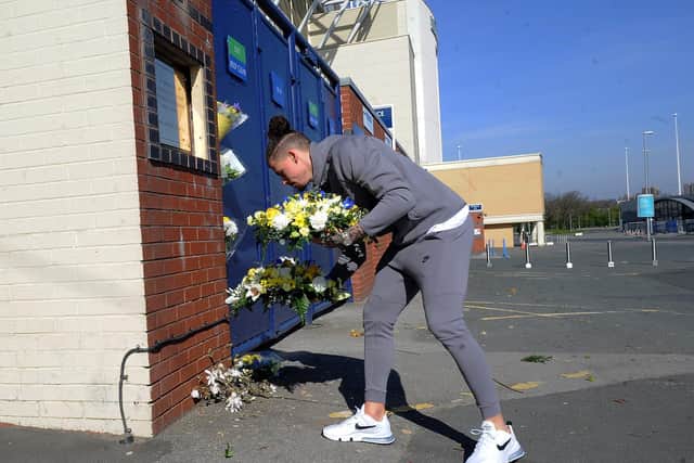 REMEMBERING: Leeds United midfielder Kalvin Phillips lays flowers in memory of Christopher Loftus and Kevin Speight at a quiet Elland Road. Picture by Simon Hulme.