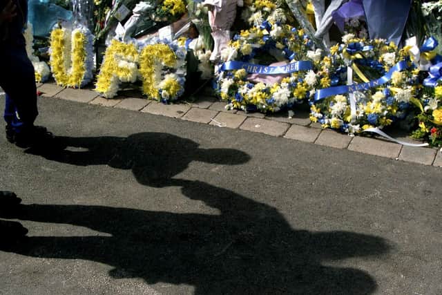 RESPECTS: Flowers are laid in memory of Christoper Loftus and Kevin Speight outside Leeds United's famous home back in 2000. Photo by ADRIAN DENNIS/AFP via Getty Images.