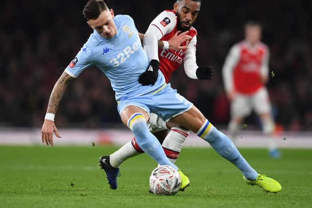 CLASSY: Leeds United's Brighton loanee Ben White holds off Arsenal striker Alexandre Lacazette during January's FA Cup tie at the Emirates. Photo by David Price/Arsenal FC via Getty Images.