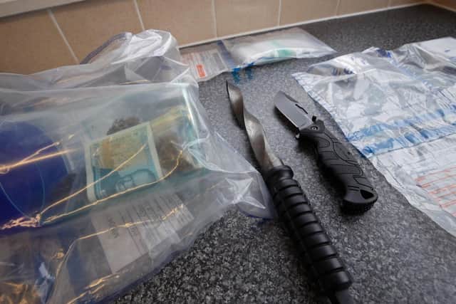 More than 10m was seized from criminals in the past financial year, West Yorkshire Police has said. Pictured: Cash and weapons seized from criminals by the Metropolitan Police.