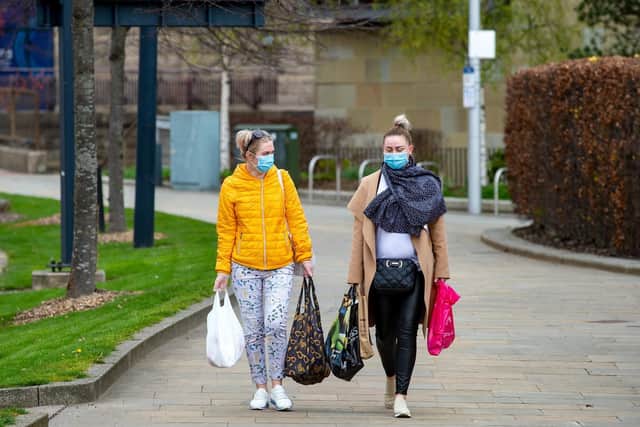 Women wear face masks with shopping in Bradford as people continue to observe social distancing rules during the Corona Virus pandemic.
9 April 2020. Picture Bruce Rollinson