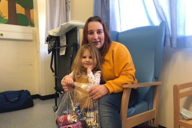 Mum Ellis Taylor, with Kaidee, three, and their bag of supplies provided by the Children's Heart Surgery Fund in Leeds.