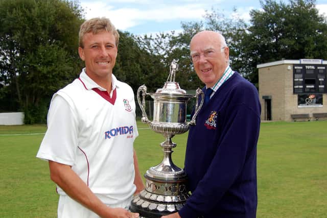 Bradford Cricket League president Keith Moss presents the Premier Division trophy to Woodlands captain Pieter Swanepoel back in 2009.
